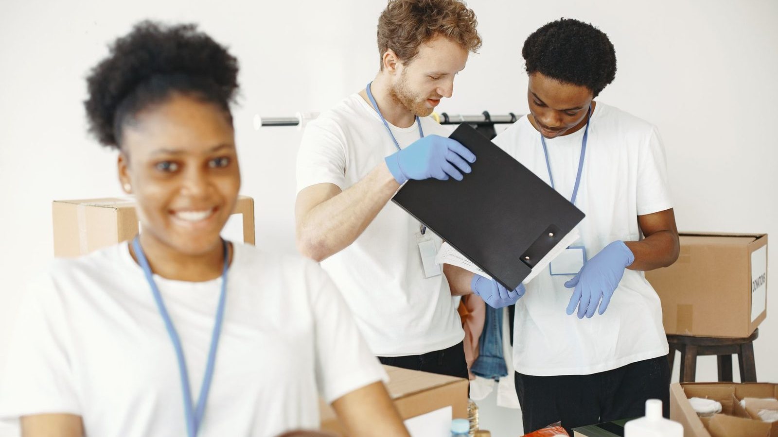 Volunteers checking a clipboard while they sort donations